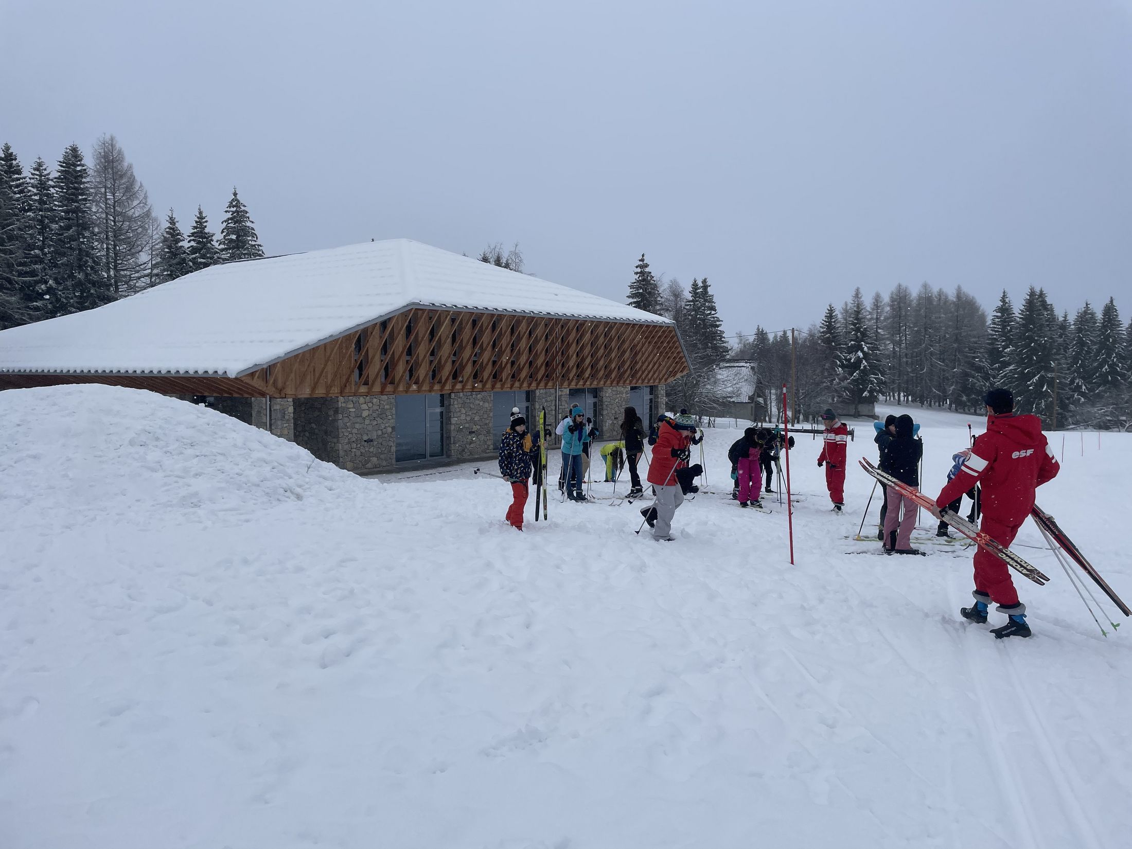 Centre nordique éducatif sportif avec des élèves chaussés en ski sur les pistes.